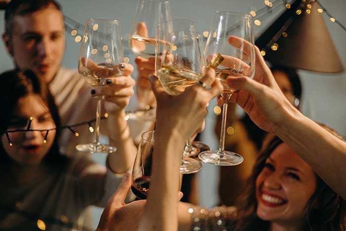 People toasting wine glasses
